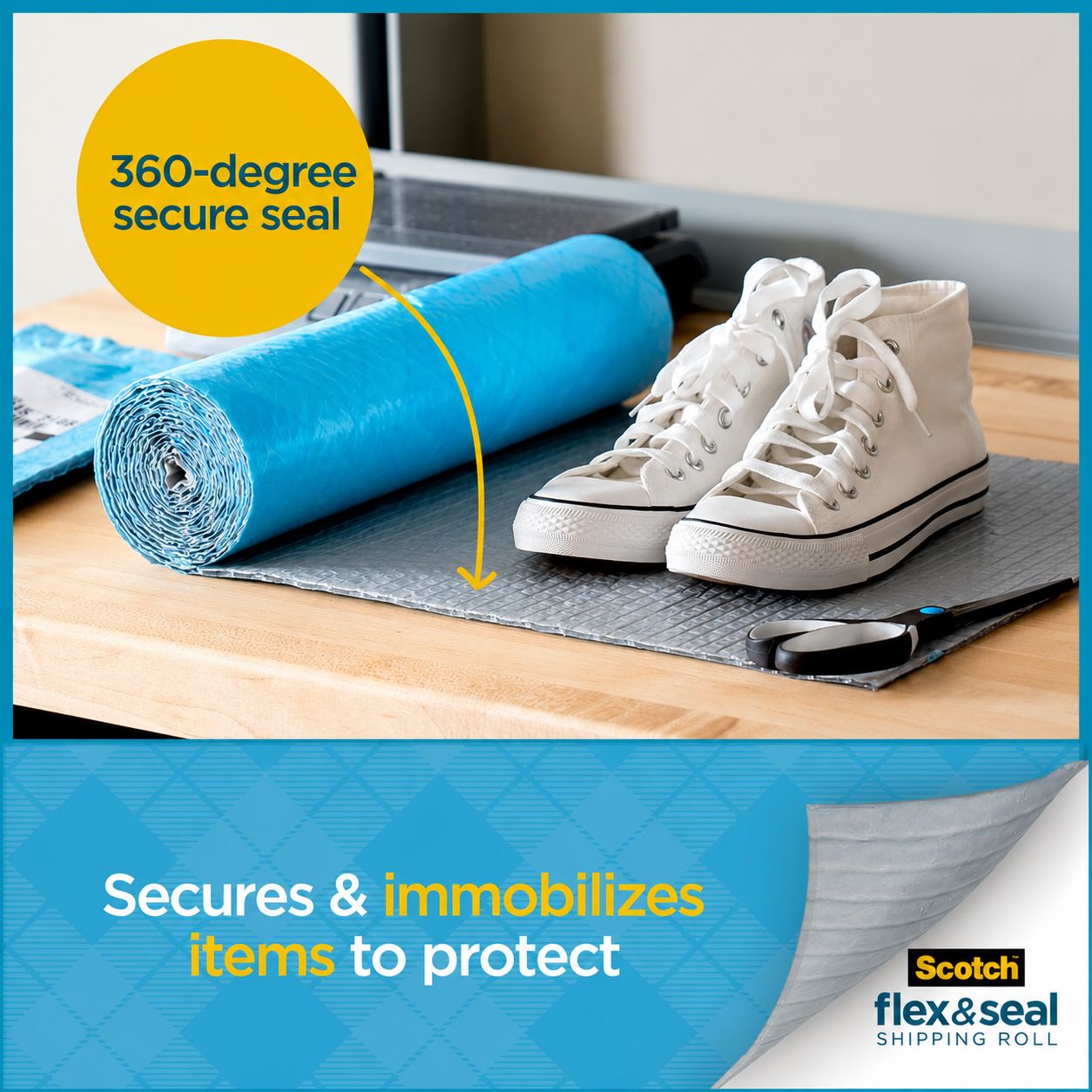 A roll of the wrap on a wooden desk beside white trainers standing on a cut grey sheet, with scissors to one side.