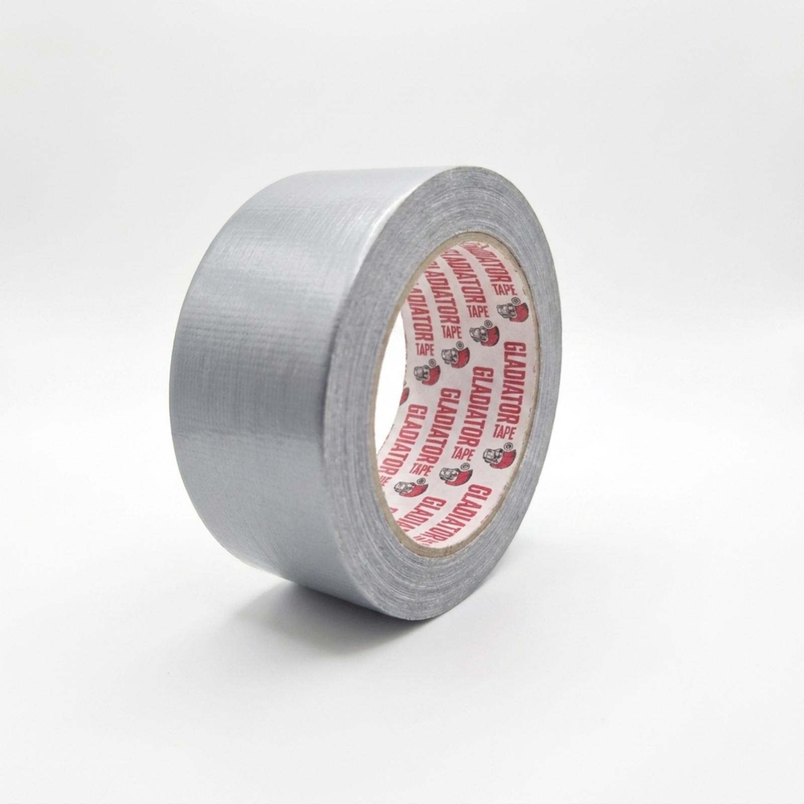 A roll of silver cloth tape standing at an angle with the core to the right, photographed against a plain pale background.