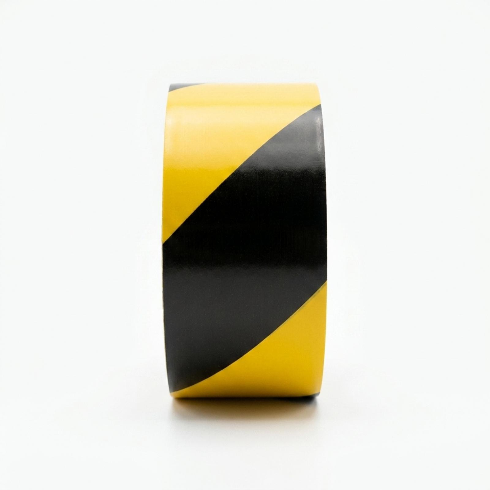A roll of hazard tape straight from the side, the diagonal black and yellow stripe pattern filling the frame.