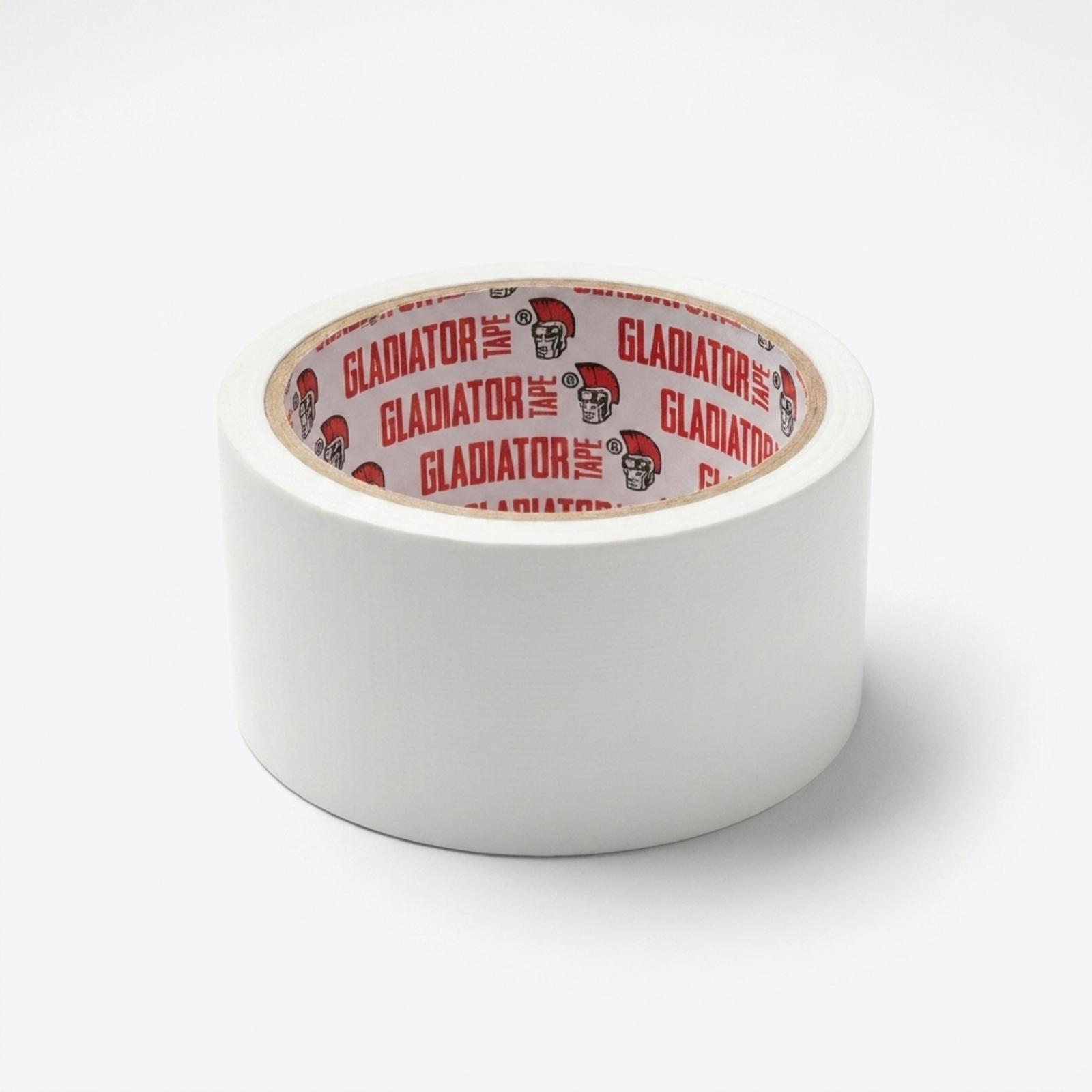 A roll of white cloth tape lying at an angle on a white surface, the Gladiator printed core facing the camera.