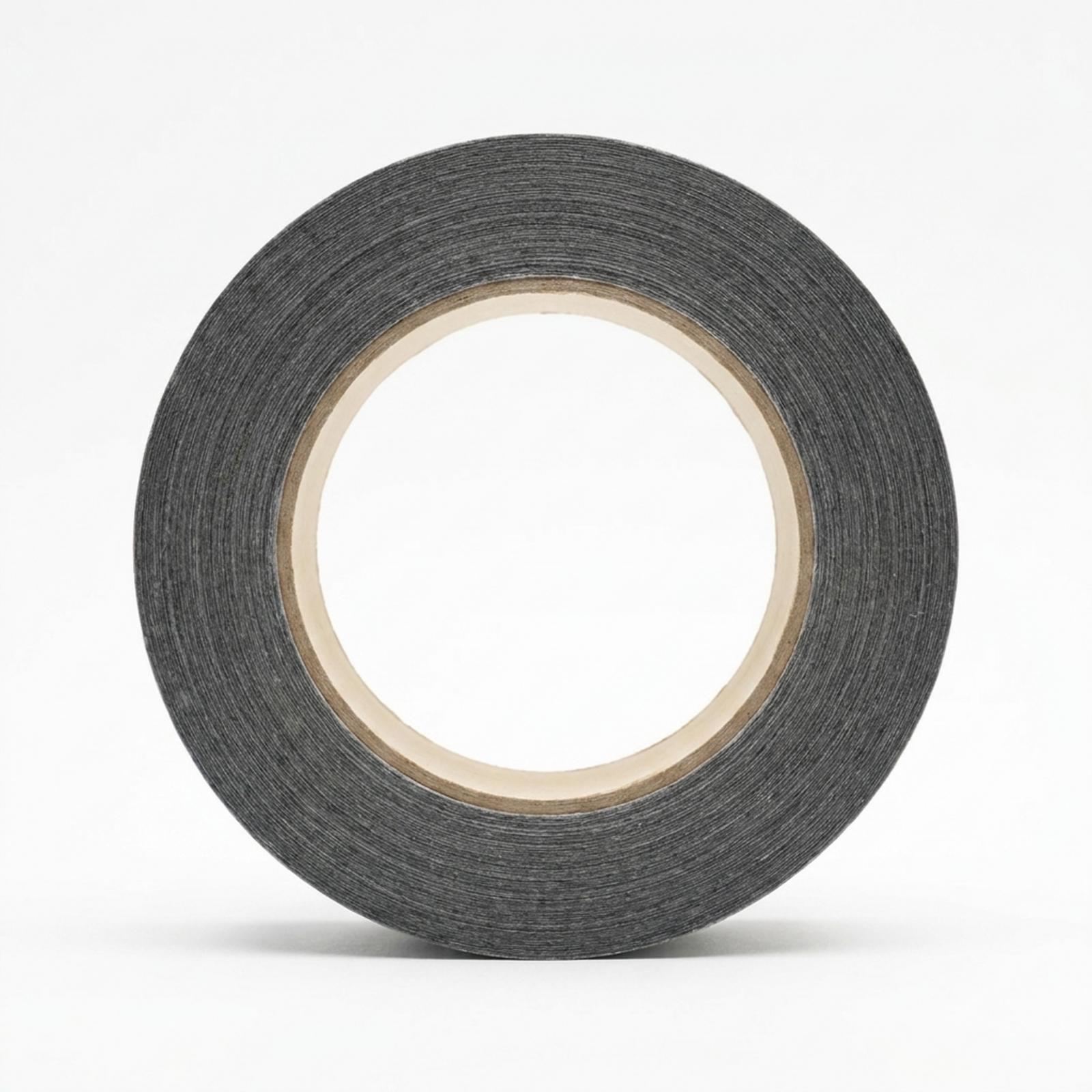 A single roll of black cloth duct tape stood face-on, its woven backing visible along the wound edge around a pale cardboard core.