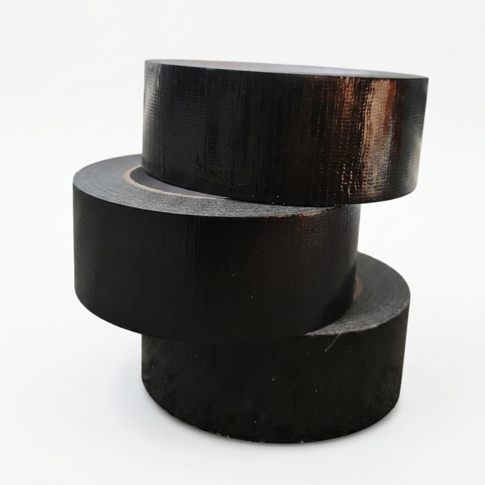 Three rolls of black cloth duct tape stacked in a staggered pile, the pack of three as supplied.